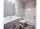 Well-lit bathroom featuring a single vanity, toilet, and tub with shower at 3292 Lions Ruby Ln, Atlanta, GA 30349