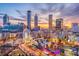 Scenic Atlanta skyline view featuring vibrant city buildings, a Ferris wheel, and a colorful sunset at 3292 Lions Ruby Ln, Atlanta, GA 30349