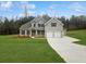 Charming gray two-story home with a well-manicured lawn and a two-car garage at 3292 Lions Ruby Ln, Atlanta, GA 30349