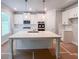 Bright kitchen featuring white cabinets, stainless steel appliances, and a spacious island with pendant lighting at 3292 Lions Ruby Ln, Atlanta, GA 30349