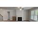 Cozy living room features a fireplace, ceiling fan, and hardwood floors at 3292 Lions Ruby Ln, Atlanta, GA 30349