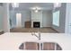 Open-concept living room view from kitchen featuring a fireplace and large windows at 3292 Lions Ruby Ln, Atlanta, GA 30349