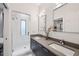 Modern bathroom featuring double sinks, a large mirror, and a glass-enclosed shower with marble tiling at 728 Oakview Rd, Decatur, GA 30030