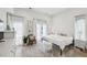 Bright bedroom with white decor, French doors, plush rug, and a cozy atmosphere, showcasing ample natural light at 728 Oakview Rd, Decatur, GA 30030