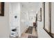 Hallway with light wood floors and white walls decorated with framed art and rustic accents at 728 Oakview Rd, Decatur, GA 30030