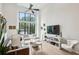 Bright living room with a large window, high ceilings, neutral decor, and a mounted television at 728 Oakview Rd, Decatur, GA 30030