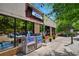 Oakhurst Market exterior showcasing ample parking, pedestrian-friendly sidewalks, and seasonal floral arrangements at 728 Oakview Rd, Decatur, GA 30030