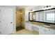 Bathroom featuring a walk-in shower, and double sink vanity with granite counters at 5712 Kendrick Ln, Cumming, GA 30041