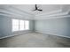 Spacious bedroom features a ceiling fan and large windows for ample natural light at 5712 Kendrick Ln, Cumming, GA 30041