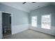 Bedroom with soft blue walls, white trim, carpet floors, and access to an ensuite bathroom at 5712 Kendrick Ln, Cumming, GA 30041