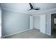 Bedroom featuring a ceiling fan, neutral walls, carpeted floors, and a closet at 5712 Kendrick Ln, Cumming, GA 30041