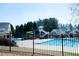Full view of community pool and slide area behind a wrought iron fence at 5712 Kendrick Ln, Cumming, GA 30041