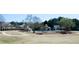 A scenic view of the community pool area, featuring a slide, clubhouse, and ample green space at 5712 Kendrick Ln, Cumming, GA 30041
