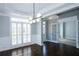Dining room featuring hardwood floors, modern lighting, and adjacent doorways at 5712 Kendrick Ln, Cumming, GA 30041