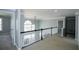 Second floor hallway with railing overlooking great room, carpet flooring, and natural light at 5712 Kendrick Ln, Cumming, GA 30041