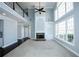 Spacious living room featuring a fireplace, tall windows, and second-floor overlook at 5712 Kendrick Ln, Cumming, GA 30041