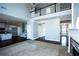 Spacious living room with fireplace, hardwood floors, and soaring ceilings open to the adjacent kitchen at 5712 Kendrick Ln, Cumming, GA 30041