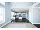 Open-concept space with a high ceiling leading to a modern kitchen, lots of windows, and hardwood floors at 5712 Kendrick Ln, Cumming, GA 30041