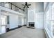 Large living room showcasing fireplace, expansive windows, and an open floor plan at 5712 Kendrick Ln, Cumming, GA 30041