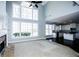 Open living area connecting to kitchen, featuring fireplace and large windows at 5712 Kendrick Ln, Cumming, GA 30041
