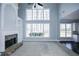 Inviting living room with tall windows, fireplace, and open layout at 5712 Kendrick Ln, Cumming, GA 30041