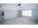 Large main bedroom with neutral colors, ceiling fan and large windows at 5712 Kendrick Ln, Cumming, GA 30041
