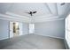 Large main bedroom with neutral colors, ceiling fan and view to main bathroom at 5712 Kendrick Ln, Cumming, GA 30041