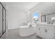 This bathroom has a free standing tub, double sinks, a glass shower and tile flooring at 6470 Pond View Dr, Cumming, GA 30028