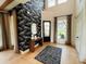 Elegant foyer featuring a bold wallpaper accent wall and a stylish mirror and console table at 6470 Pond View Dr, Cumming, GA 30028