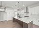 Modern kitchen with white cabinets, stainless steel appliances, pendant lighting, and large island at 6470 Pond View Dr, Cumming, GA 30028
