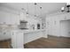 Modern kitchen with white cabinetry, a central island, and pendant lighting at 6470 Pond View Dr, Cumming, GA 30028