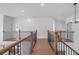 Spacious loft area with wood floors and wrought iron railings at 6470 Pond View Dr, Cumming, GA 30028