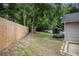 Backyard with a wooden fence, playhouse, and mature trees providing privacy at 972 Sims Nw Ave, Atlanta, GA 30318