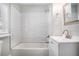 Updated bathroom featuring a subway tile shower and white vanity with modern fixtures at 972 Sims Nw Ave, Atlanta, GA 30318