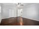 Spacious bedroom featuring hardwood floors, a ceiling fan, and closet doors at 972 Sims Nw Ave, Atlanta, GA 30318