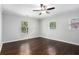 Bright bedroom featuring hardwood floors, ceiling fan and multiple windows at 972 Sims Nw Ave, Atlanta, GA 30318