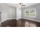 Sunlit bedroom with hardwood floors, and a large window overlooking the neighborhood at 972 Sims Nw Ave, Atlanta, GA 30318