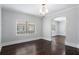 Inviting dining room with dark hardwood floors, large windows, and a stylish chandelier at 972 Sims Nw Ave, Atlanta, GA 30318