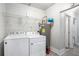 Functional laundry room with washer, dryer, and storage shelving at 972 Sims Nw Ave, Atlanta, GA 30318