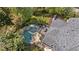 Aerial view of a backyard featuring a private pool, hot tub, deck and lush landscaping for relaxing outdoor living at 9985 High Falls Pointe, Johns Creek, GA 30022