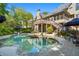 Expansive backyard features a large pool, elegant lounge furniture, and mature trees at 9985 High Falls Pointe, Johns Creek, GA 30022