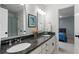 Bright bathroom featuring double vanity with granite counters, white cabinetry, and doorway view to bedroom at 9985 High Falls Pointe, Johns Creek, GA 30022