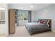 Comfortable bedroom with a large window, a built-in bookcase, and an ensuite bathroom at 9985 High Falls Pointe, Johns Creek, GA 30022