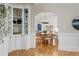 Elegant dining room with hardwood floors, built-in shelving, and arched entryway to the kitchen at 9985 High Falls Pointe, Johns Creek, GA 30022