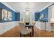 Beautiful dining room with striking blue wallpaper, designer light fixture, and hardwood floors at 9985 High Falls Pointe, Johns Creek, GA 30022