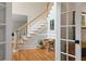 Inviting foyer featuring a wooden staircase, wainscoting, hardwood floors and tasteful decorations for a welcoming ambiance at 9985 High Falls Pointe, Johns Creek, GA 30022