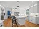 Bright kitchen features white cabinets, marble counters, a center island, and stainless steel appliances at 9985 High Falls Pointe, Johns Creek, GA 30022
