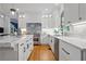 Spacious kitchen featuring white cabinets, a marble countertop, stainless steel appliances, and hardwood floors at 9985 High Falls Pointe, Johns Creek, GA 30022