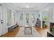 Bright living room with large windows, hardwood floors, a modern ceiling fan and plenty of natural light at 9985 High Falls Pointe, Johns Creek, GA 30022