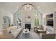 Bright living room with high ceilings, fireplace, large windows, hardwood floors and stylish furnishings at 9985 High Falls Pointe, Johns Creek, GA 30022